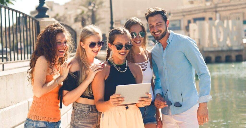 Group Of People Standing Beside Body Of Water