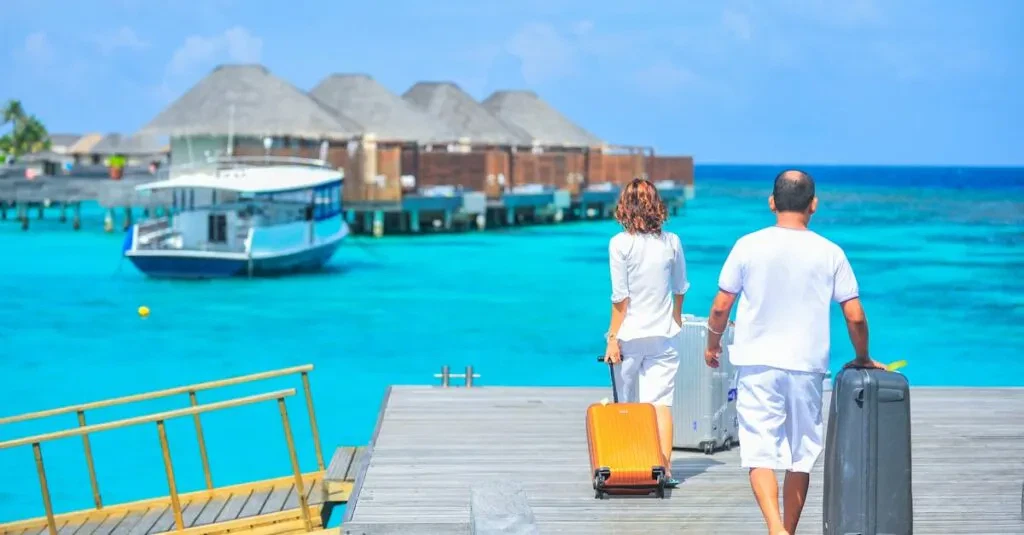 Redefine Luxury Travel With Black Car Rental Services 7 April 16, 2026 A Couple Arriving At A Luxurious Maldives Resort Dock With Luggage, Capturing A Tropical Vacation Vibe.
