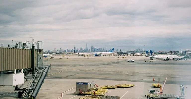 Aircraft Waiting On Jfk Airport Apron With New York City Skyline In The Background.