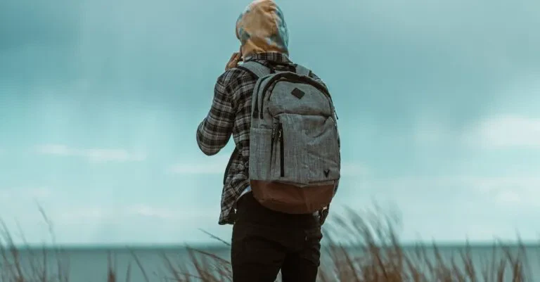 A Man With A Backpack Enjoys A Serene Oceanside View In Atlantic City, New Jersey.