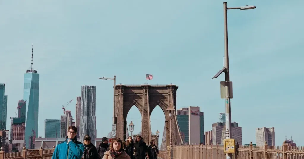 View Of The Iconic Brooklyn Bridge With Pedestrians And Manhattan Skyline In New York City.