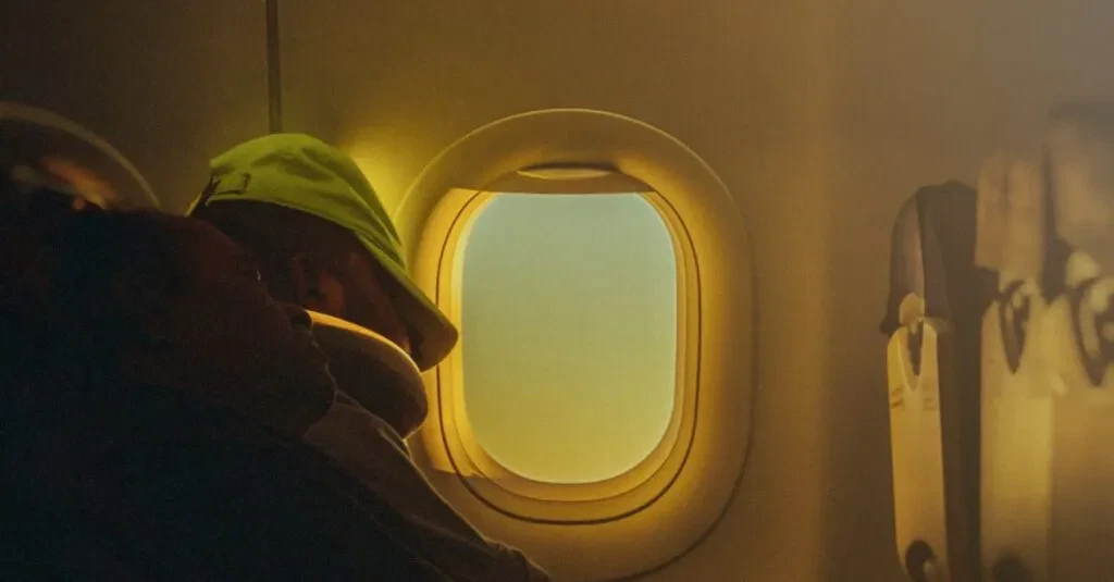 A Person Rests Peacefully By An Airplane Window, Warm Light Filtering Through.