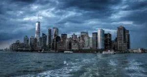 Dramatic View Of New York City Skyscrapers Against A Moody Twilight Sky.