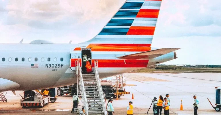 A Colorful Airliner Being Prepared For Boarding On A Sunny Day At An Airport.