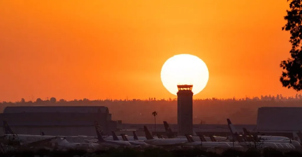 Airplanes At San Bernardino Airport Silhouetted Against A Vibrant Sunset.