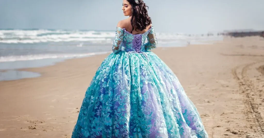 A Woman In A Stunning Blue Ball Gown Poses On A Serene Beach, Showcasing Elegance And Beauty.
