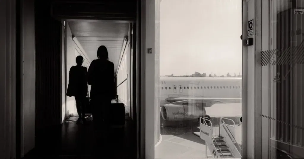 Silhouetted Travelers Walking Through An Airport Jet Bridge Toward An Airplane, Conveying A Travel Mood.