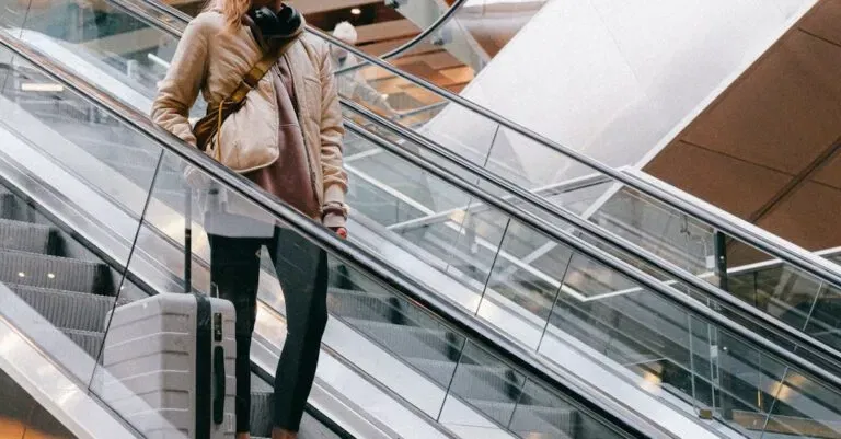 New Jersey Blogs | Articles | News | Tips &Amp; Tricks | Video | Faq | Information | Infograph. 28 April 13, 2026 Woman With Luggage Wearing Face Mask On Escalator In Airport During Pandemic.