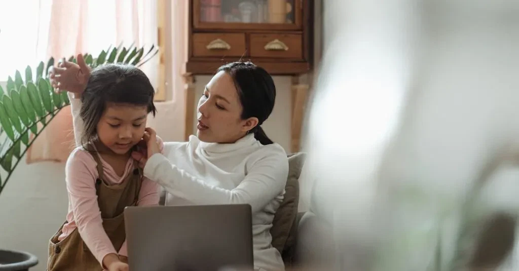 A Mother And Daughter Enjoy Quality Time Together Using A Laptop On A Comfortable Couch In A Cozy Living Room.