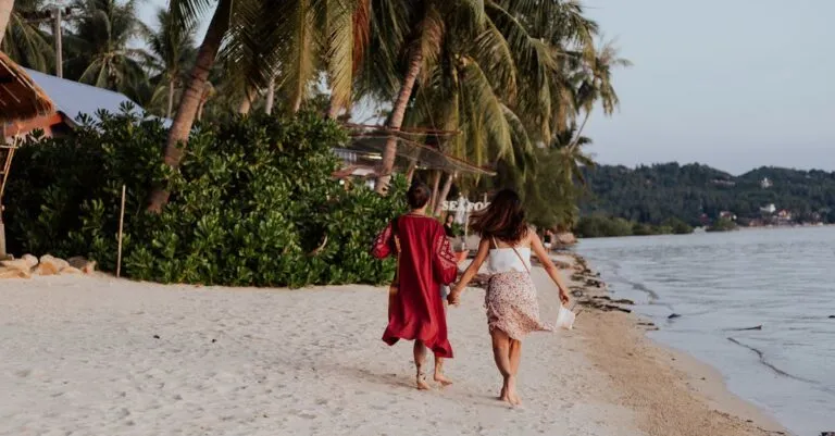 New York Blogs | Articles | News | Tips &Amp; Tricks | Video | Faq | Information | Infograph. 4 June 11, 2026 Two Women Holding Hands And Walking Along A Sandy Tropical Beach, Enjoying Their Summer Vacation.