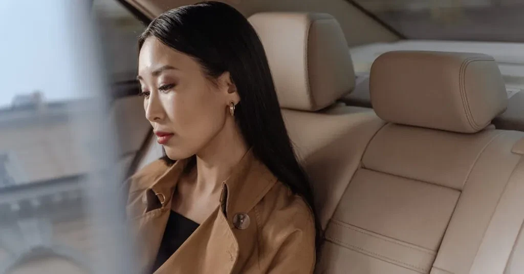 Car Service Booking With Jetblack Your Ride, Your Way 1 April 14, 2026 An Elegant Asian Woman Sits Thoughtfully In A Luxurious Car Interior.