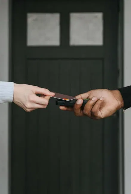 Close-Up Of Hands Exchanging Credit Card For Contactless Payment, Emphasizing Cashless Transactions.
