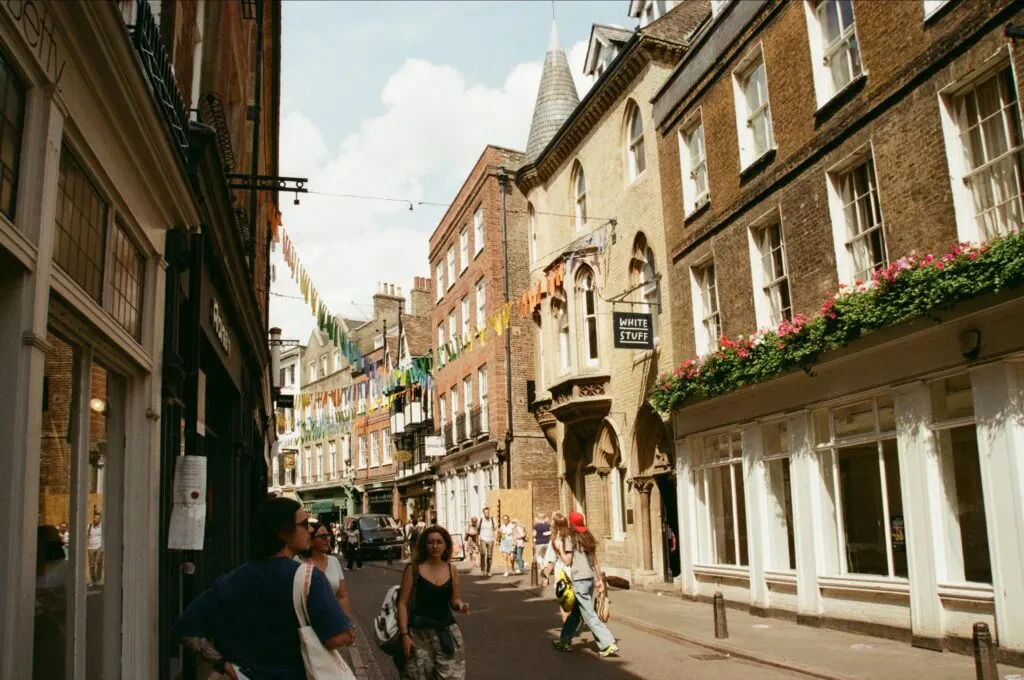 Vibrant Street Scene With People And Historic Buildings In Cambridge, England.