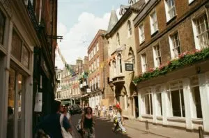 Vibrant Street Scene With People And Historic Buildings In Cambridge, England.
