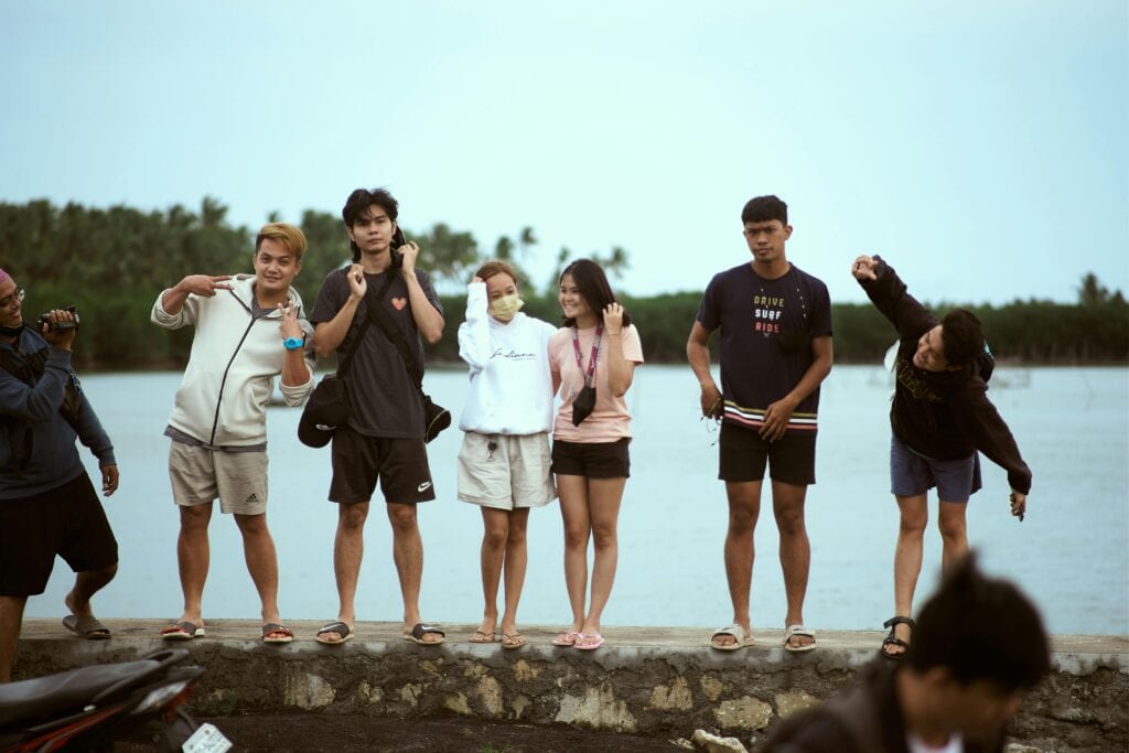A Group Of Friends Enjoying A Moment Together By A Scenic Lakeside, Showing Joy And Togetherness.