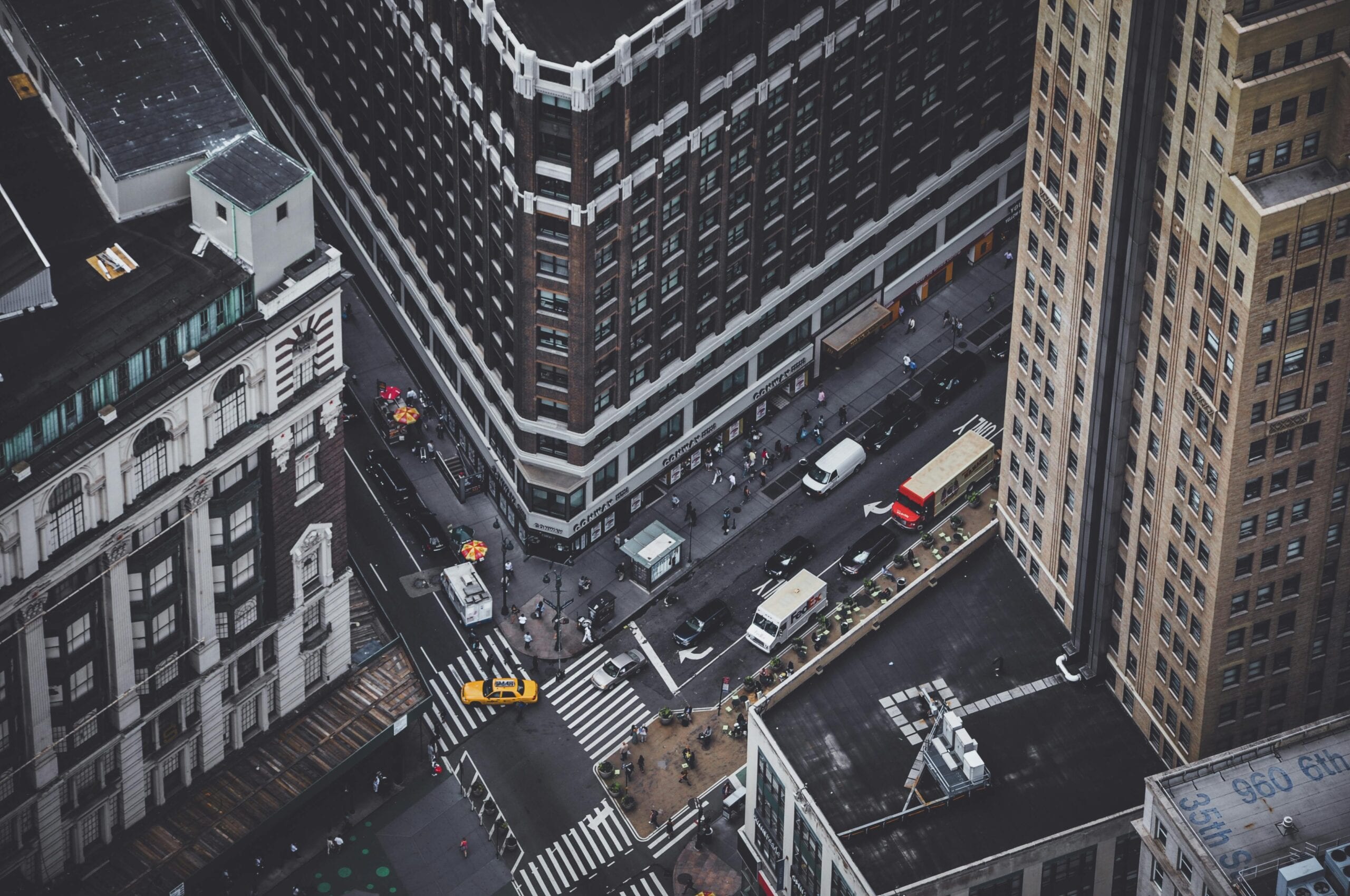 Aerial View Of A Bustling Intersection In New York City Showing Traffic And Skyscrapers.