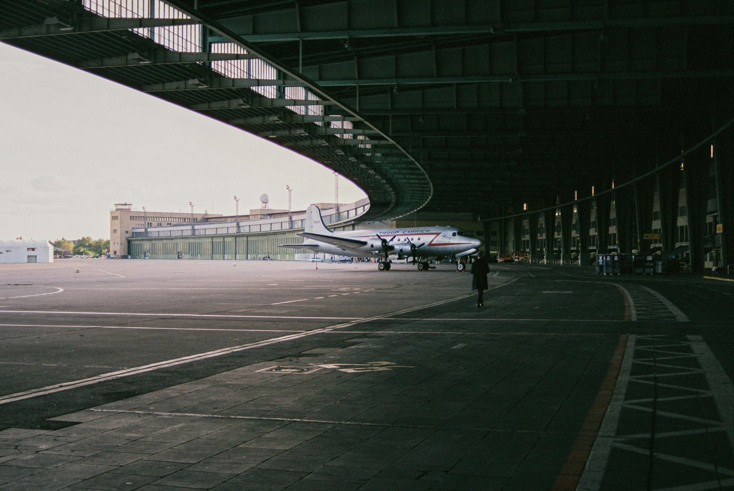 A Classic Aircraft Parked Inside An Iconic Berlin Hangar, Showcasing Aviation History.