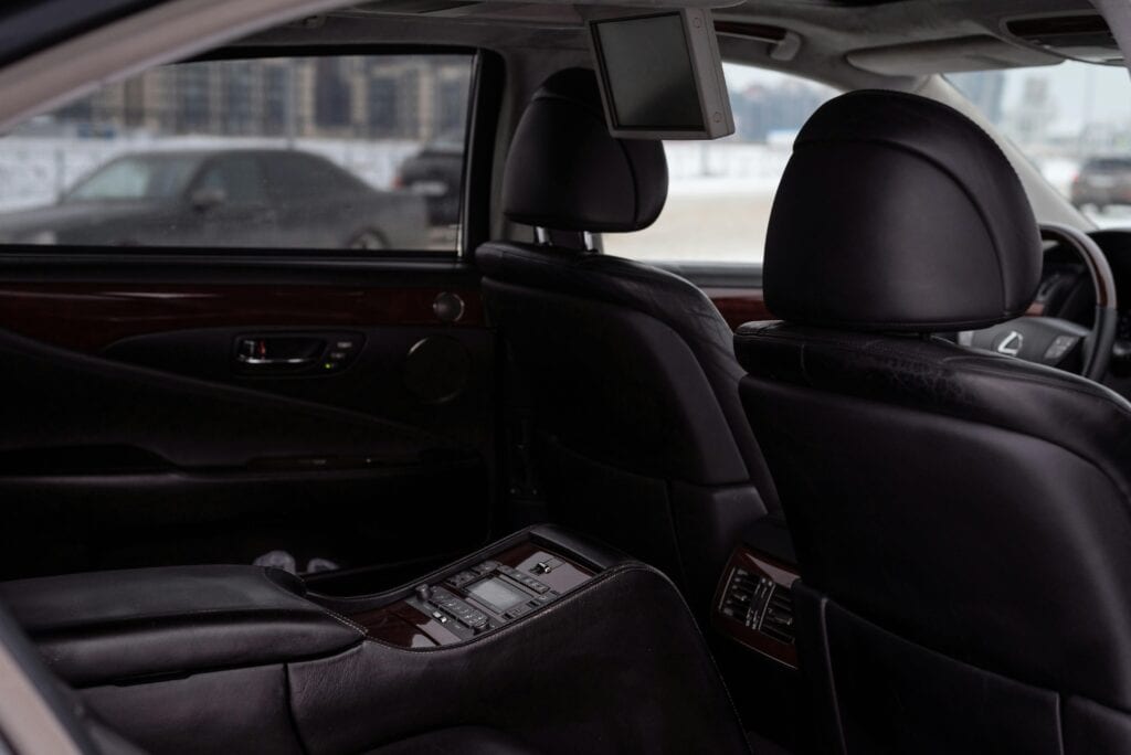 Elegant Interior Of A Luxury Vehicle With Black Leather Seats And Wood Paneling. Perfect For Travel And Comfort Images.
