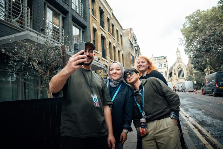 New York Blogs | Articles | News | Tips &Amp; Tricks | Video | Faq | Information | Infograph. 12 June 11, 2026 Group Of Friends Taking A Selfie On A Lively Street In London With A Church In The Background.