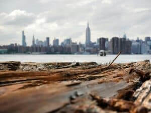 Rustic Wood Foreground With New York City Skyline In The Background Under Cloudy Sky.