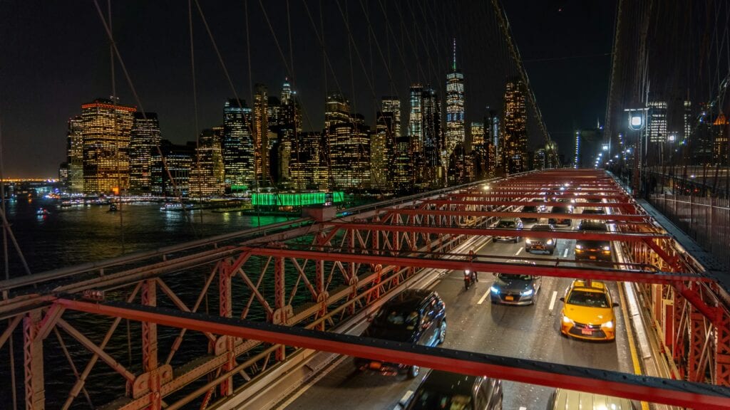 Stunning Night View Of Manhattan Skyline And Traffic On Brooklyn Bridge, New York City.
