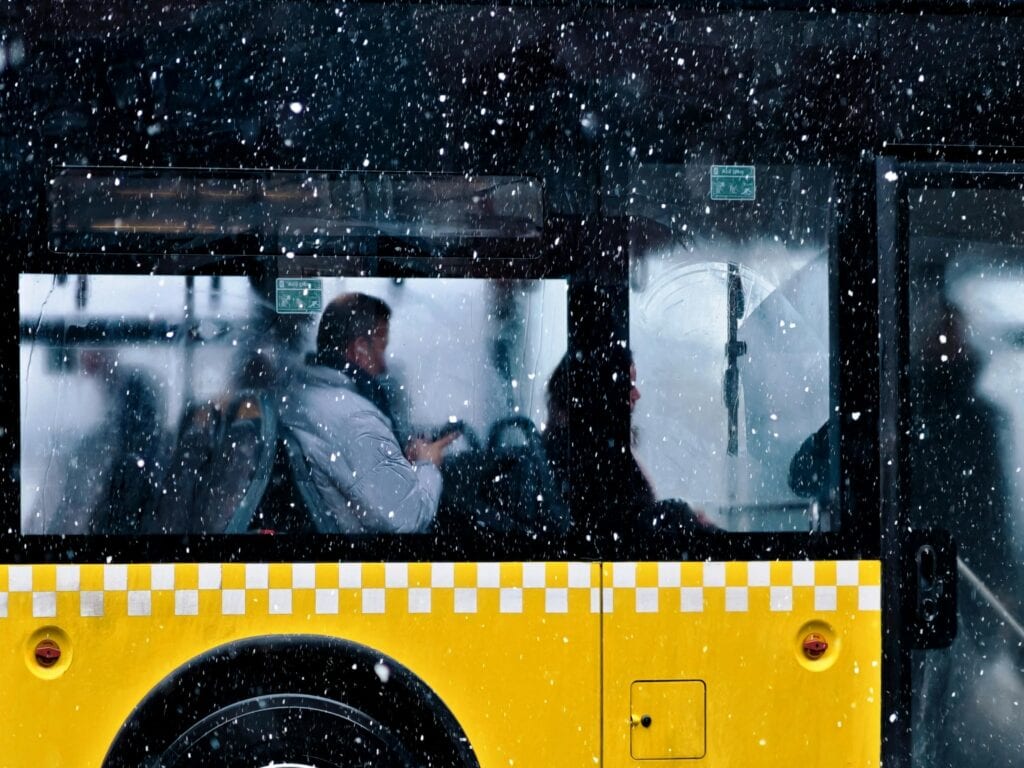 A Person Inside A Yellow Bus During A Snowfall In Istanbul, Türkiye.
