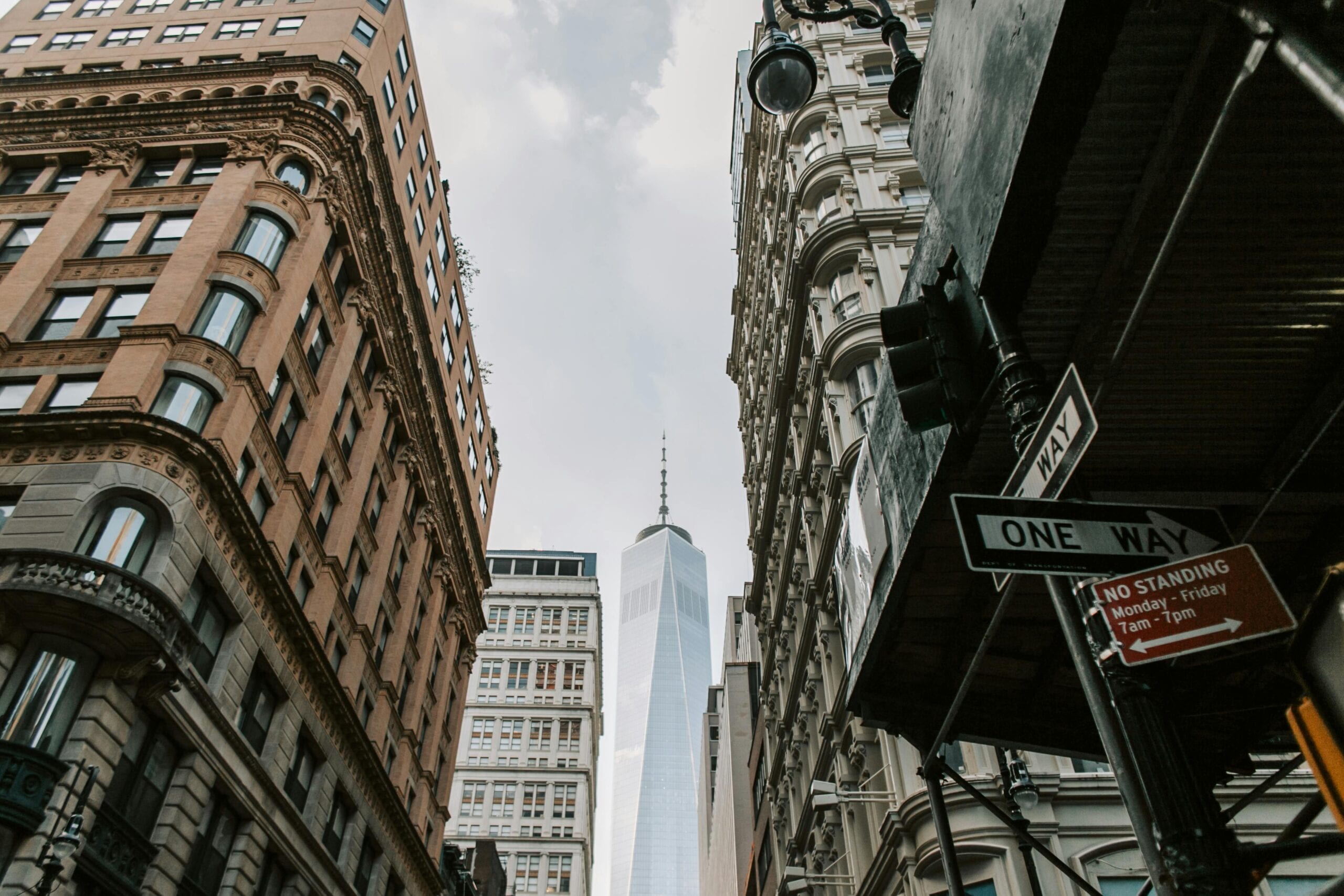 View Of One World Trade Center From A Busy Downtown New York Street.