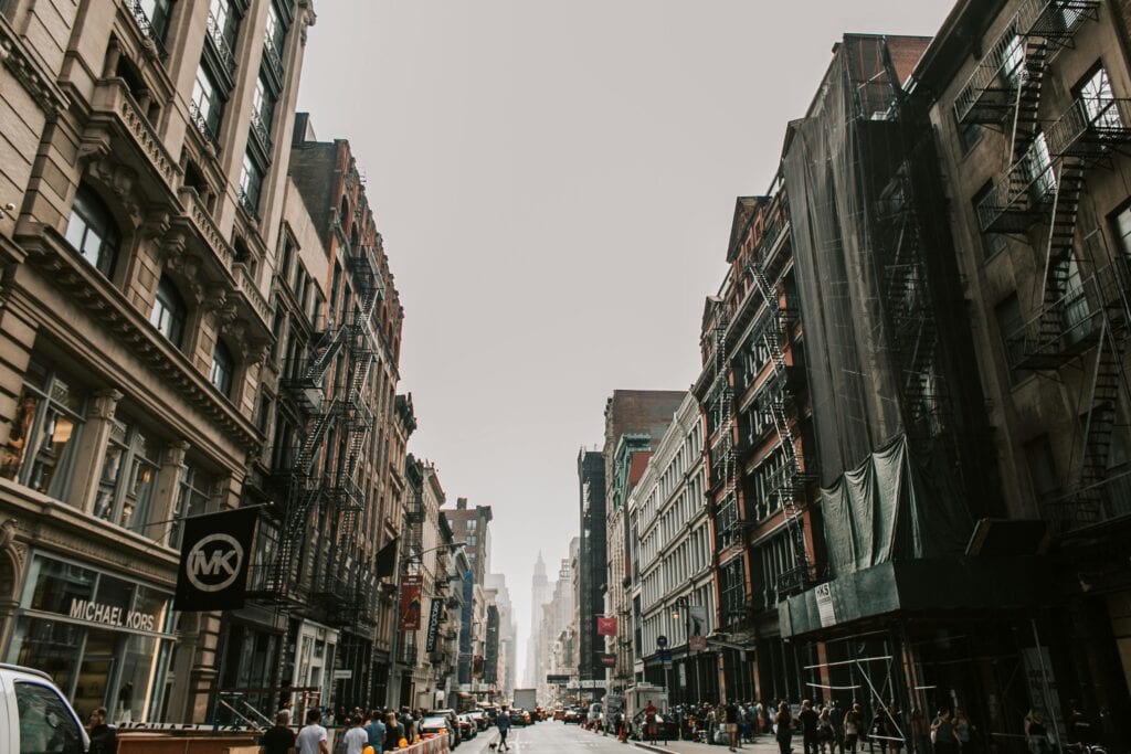 Bustling Manhattan Street Scene Showcasing Iconic Urban Architecture In New York City.