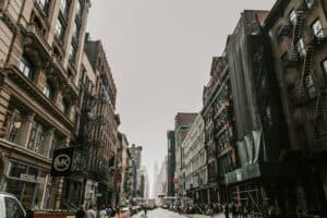 Bustling Manhattan Street Scene Showcasing Iconic Urban Architecture In New York City.