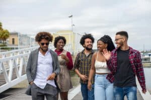 Airport Transfer Articles &Amp; News 2 June 13, 2026 A Joyful Group Of Friends Walking And Smiling On A Boardwalk By The Marina In Portugal.