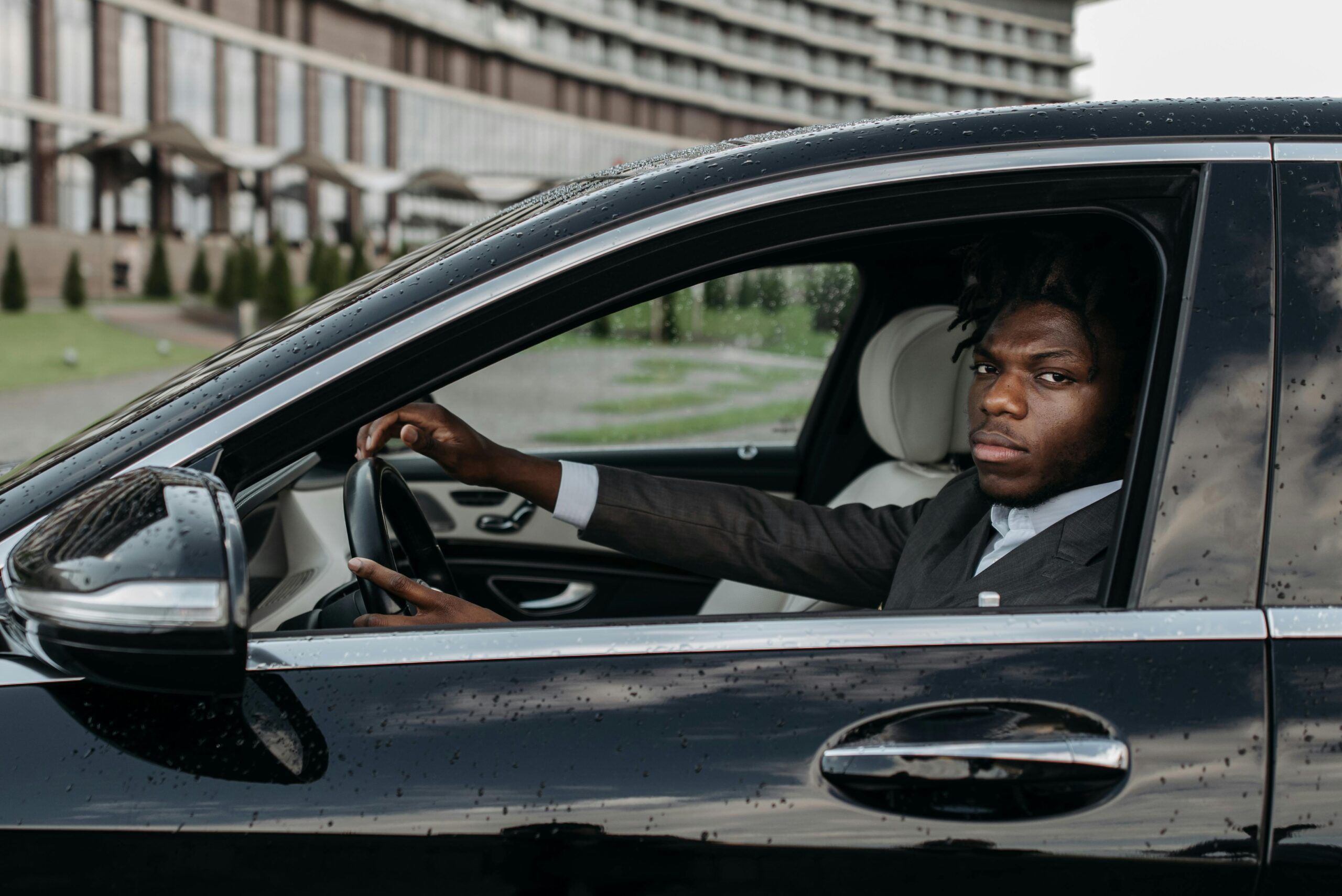 Blogs | Articles | News | Tips &Amp; Tricks | Video | Faq | Infomation 5 April 12, 2026 African American Man Confidently Driving A Sleek Black Luxury Car Outside A Modern Building.