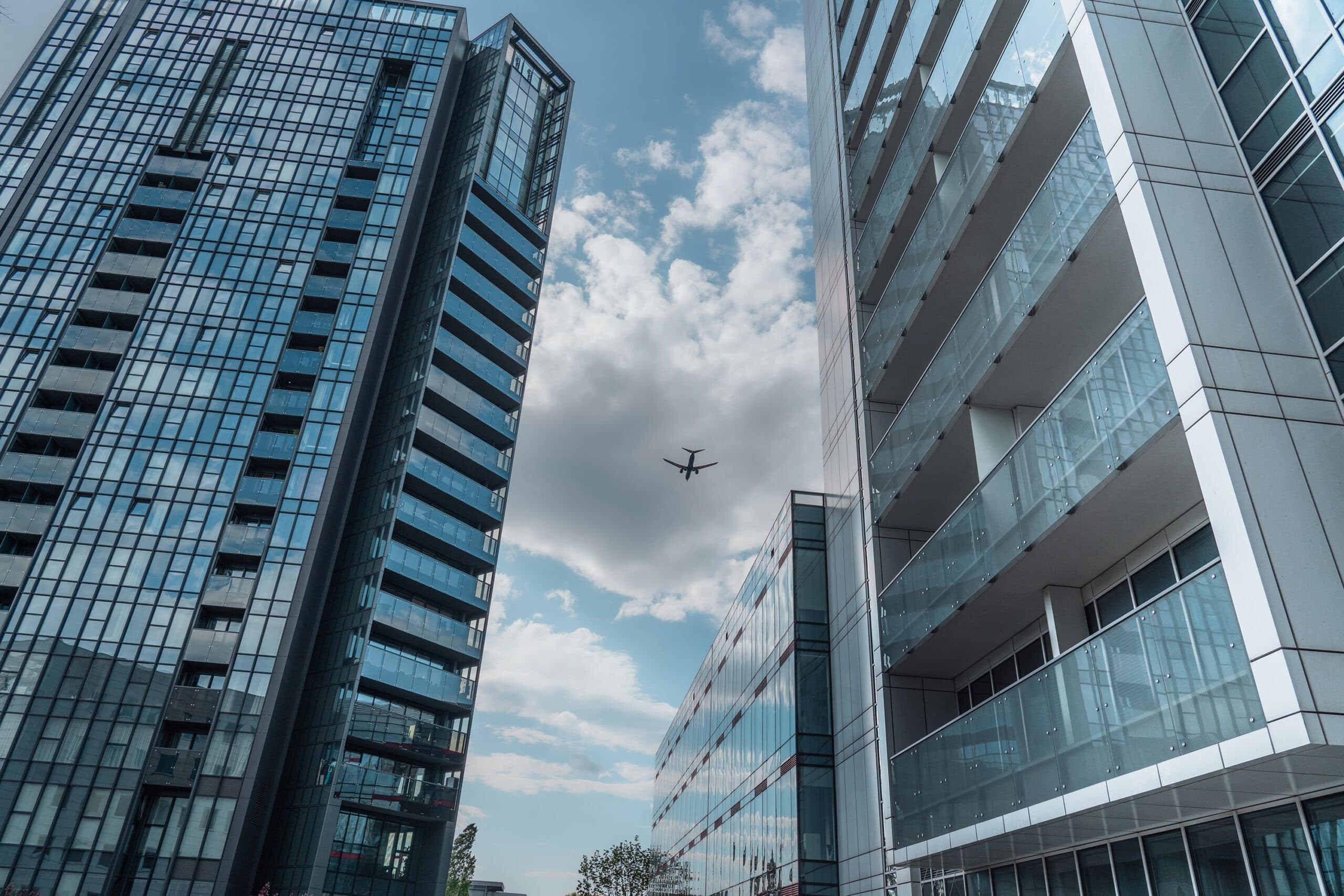 Blogs | Articles | News | Tips &Amp; Tricks | Video | Faq | Infomation 14 May 25, 2026 Modern Skyscrapers In Poznań With An Airplane Soaring Above On A Clear Day.