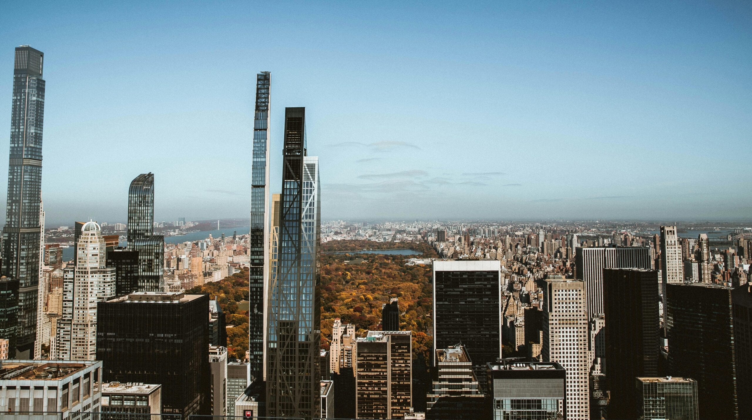High-Rise View Overlooking Central Park And New York Skyscrapers Under A Clear Blue Sky.