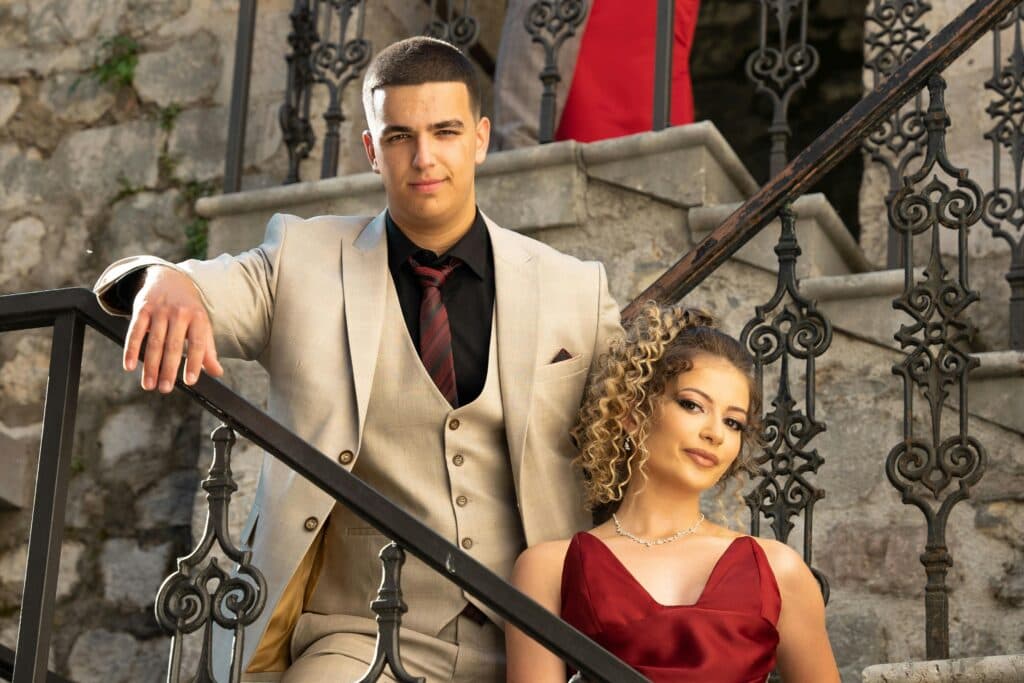 Nyc Prom Limousine 2026: 5 Honest Facts Before You Book 4 June 2, 2026 Stylish Couple Dressed Formally Posing On Ornate Staircase With Stone Walls.