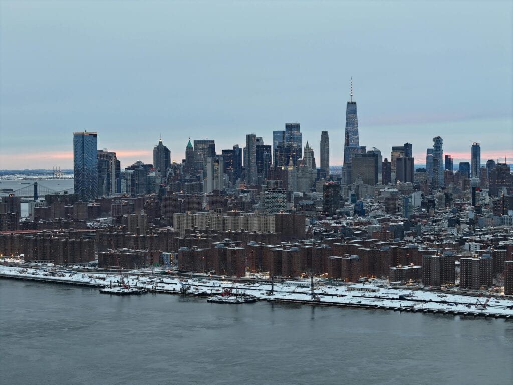 Manhattan Airport Nyc: 5 Honest Options For Families With Luggage 2026 7 May 24, 2026 A Stunning Aerial Shot Of New York City Skyline Covered In Snow During The Day.