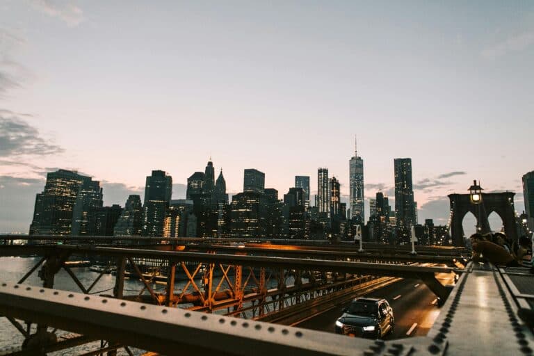 Breathtaking View Of New York City'S Illuminated Skyline From The Brooklyn Bridge At Dusk.