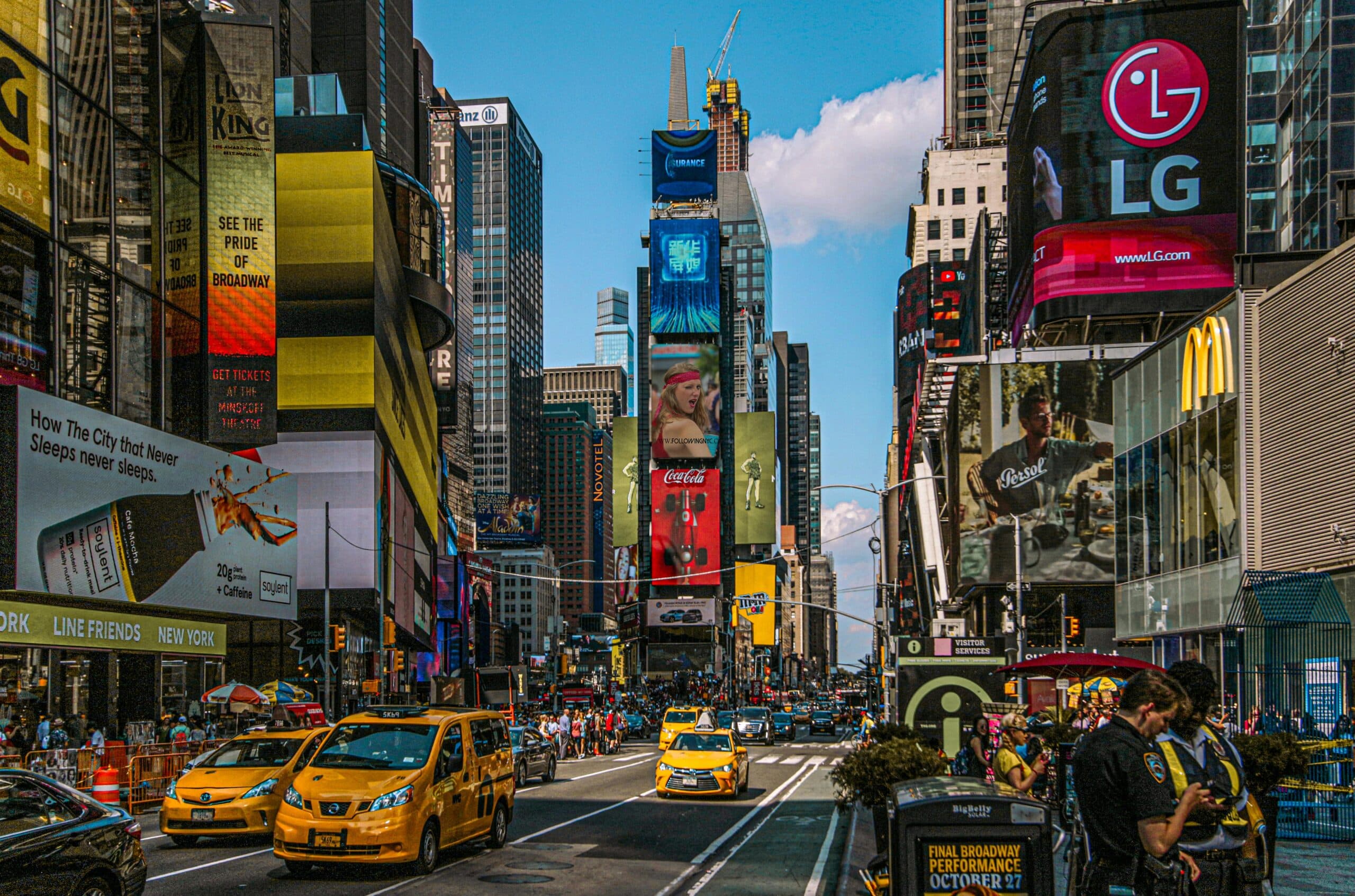 Dynamic Street View Of Times Square, Nyc Filled With Billboards, Taxis, And People.