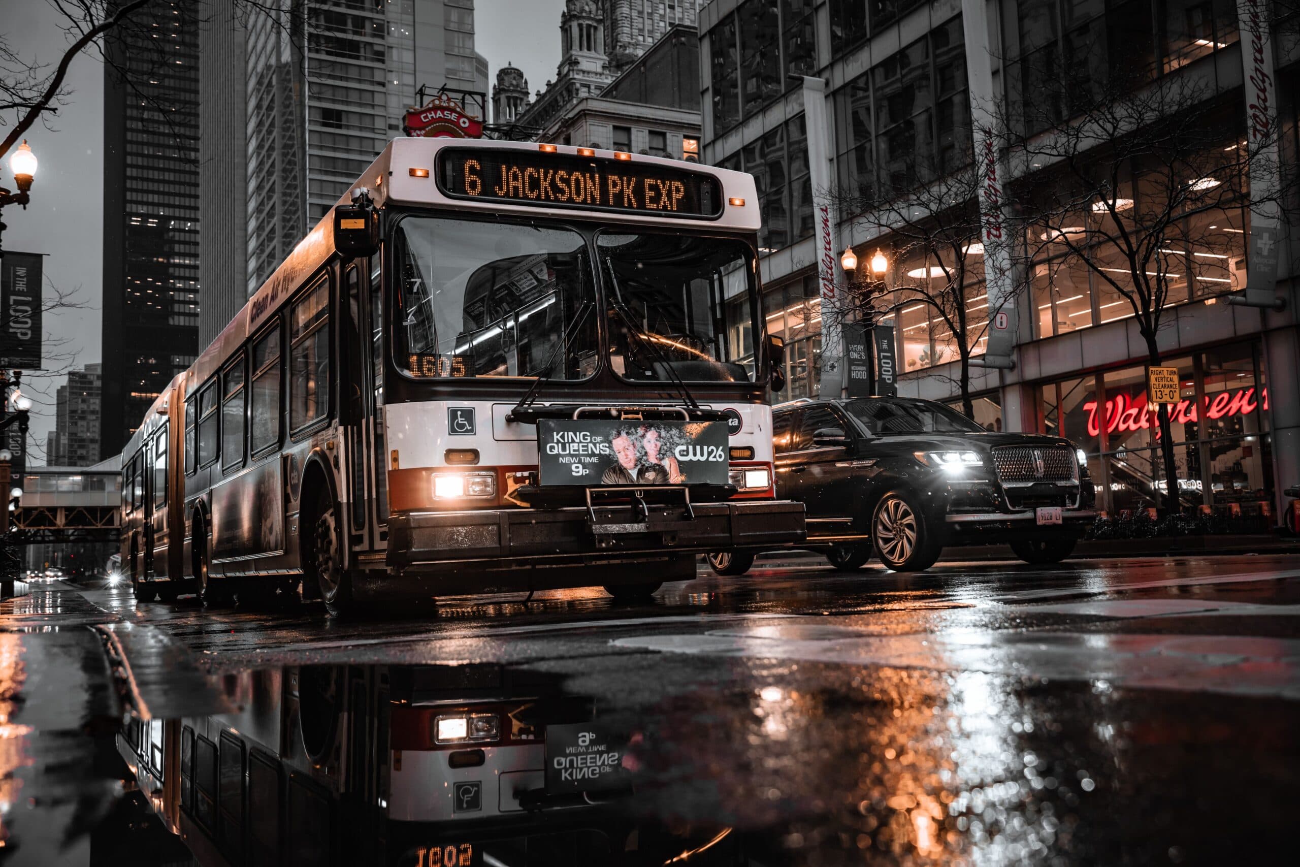 City Bus And Cars Reflected On Wet Street In Chicago&Amp;Apos;S Urban Landscape At Night.