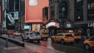 Vibrant Street View Of Times Square, New York City Featuring Taxis, Billboards, And Urban Architecture.