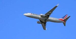 Boeing 737 Aircraft Flying Under A Clear Blue Sky, Showcasing Aviation In Motion.