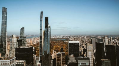 High-Rise View Overlooking Central Park And New York Skyscrapers Under A Clear Blue Sky.