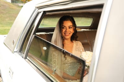 Radiant Bride Holding Bouquet In A Limousine, Preparing For Wedding Ceremony.
