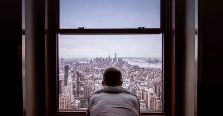 Man In Gray Shirt Looking At City Buildings