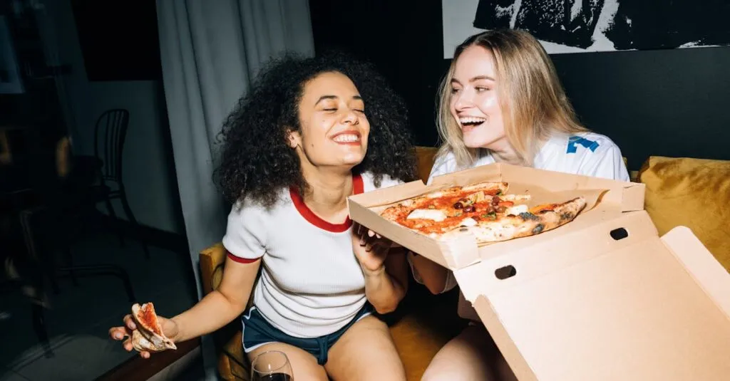 Exploring the best places to eat near JFK: A Gastronomic Affair 2 Two happy friends laughing and enjoying pizza indoors during a cozy night in.