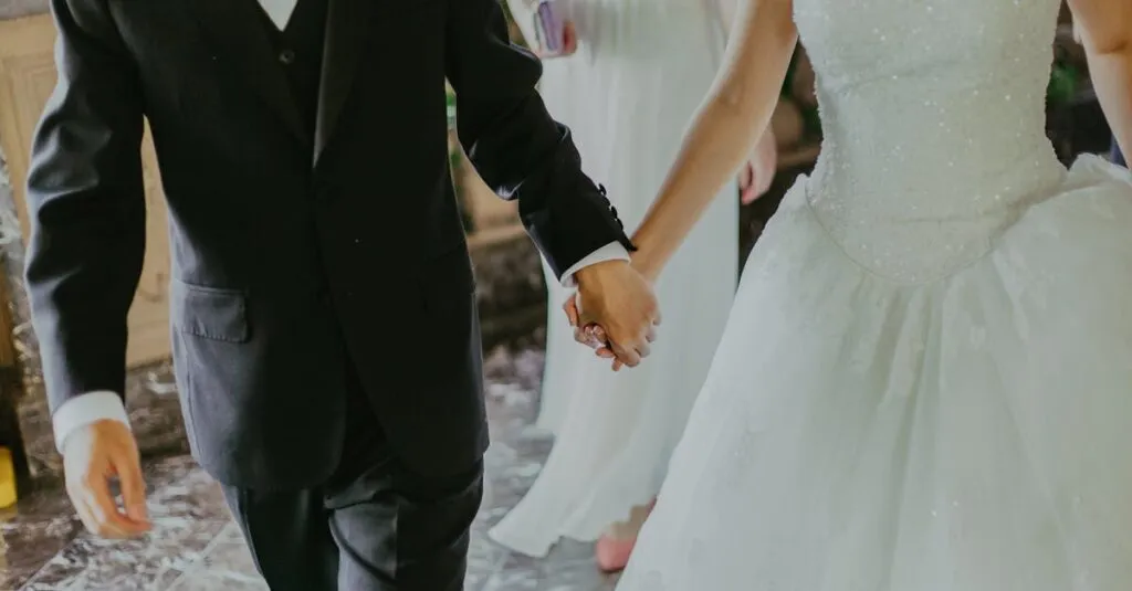 A Romantic Moment Capturing A Bride And Groom Holding Hands In Elegant Wedding Attire Indoors.