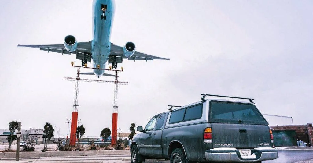 A Striking Image Capturing An Airplane Landing Closely Over A Parked Truck On A Tarmac.