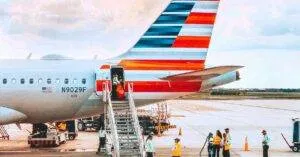 A Colorful Airliner Being Prepared For Boarding On A Sunny Day At An Airport.