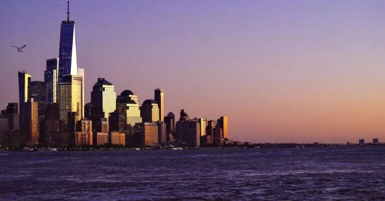 Breathtaking View Of New York City Skyline At Sunset With Waterfront And Iconic Skyscrapers.