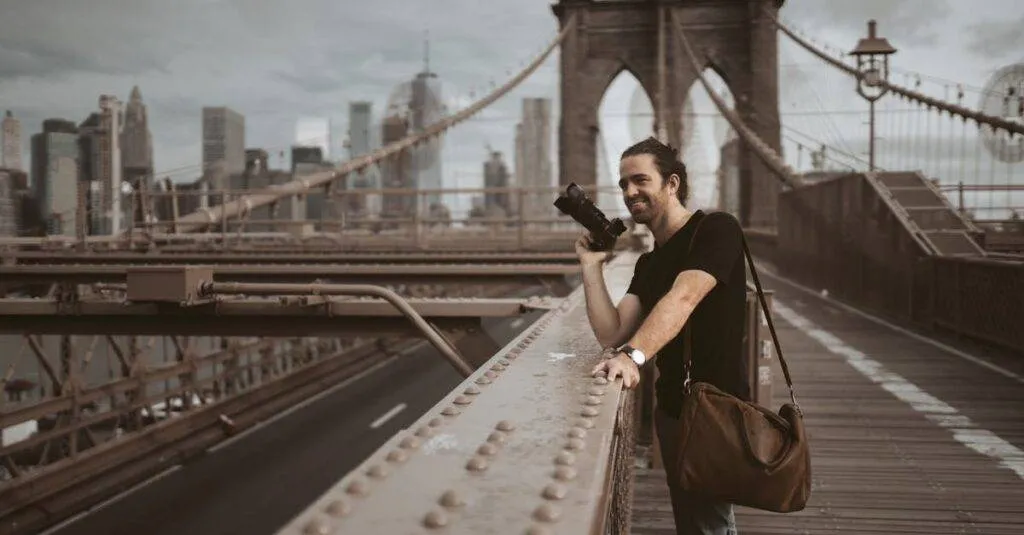 Landing Pages 4 January 31, 2026 Man Photographing On Brooklyn Bridge With New York City Skyline In Background.