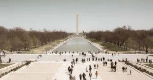 A Crowd Enjoys A Sunny Day At The Washington Monument Reflection Pool, A Popular Tourist Spot In Washington, D.c.